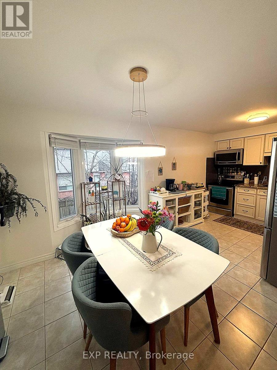 A dining room with a table set for two and a view of the backyard.