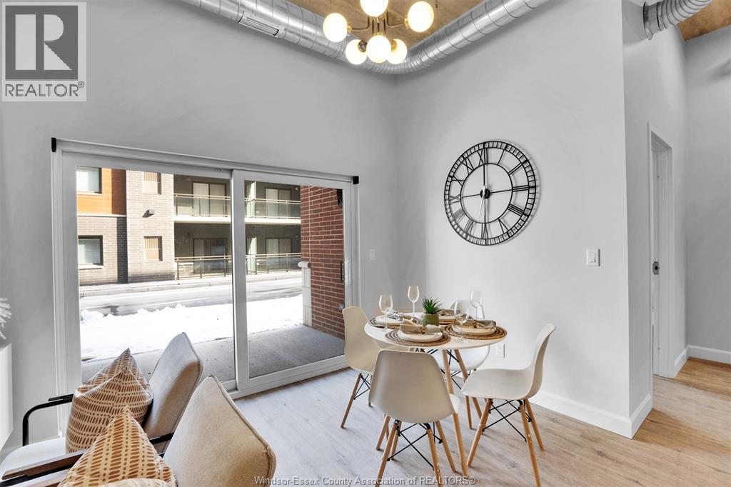 A dining room with a table set for two and a large window.