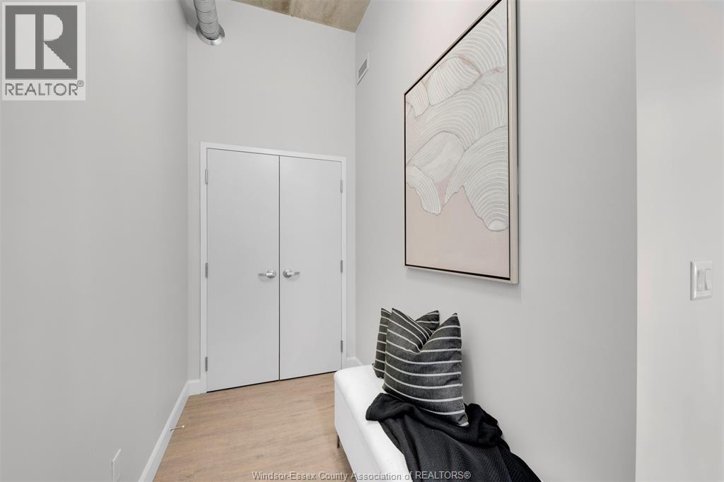 A bedroom with a bed, pillows and a painting on the wall.
