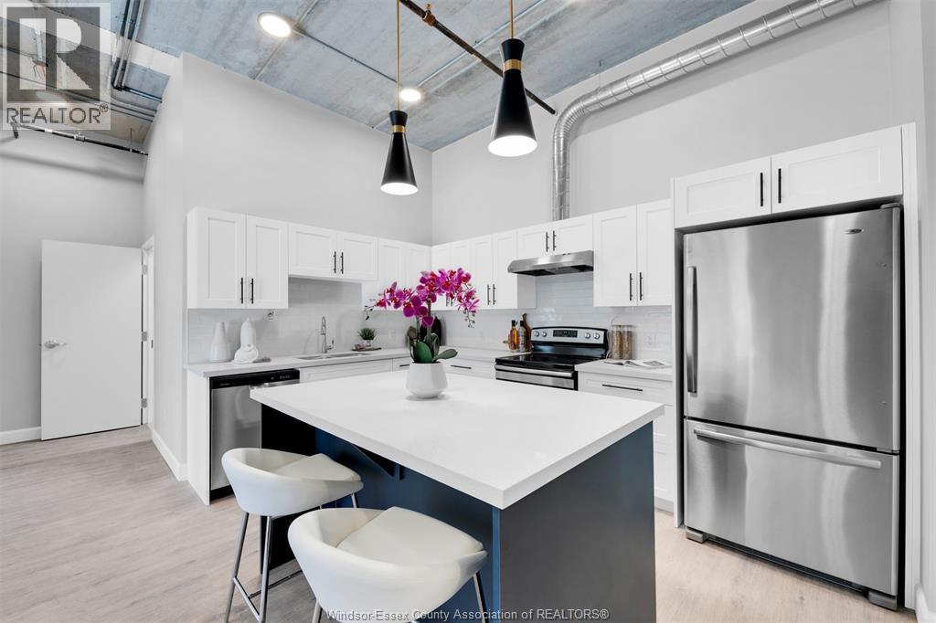 A modern kitchen with white cabinets and a large island.