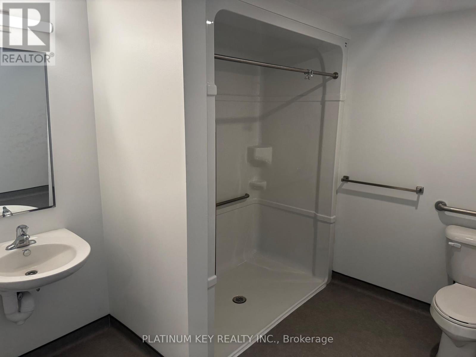 A bathroom with a sink, toilet, and shower.