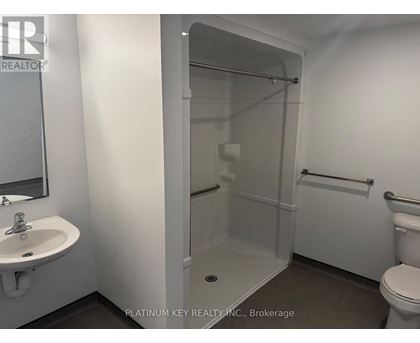 A bathroom with a sink, toilet, and shower.