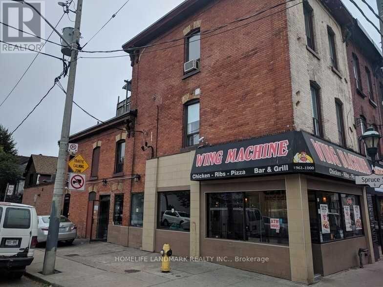 A brick building with a sign that says wing machine.