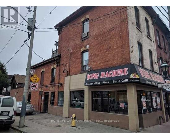 A brick building with a sign that says wing machine.