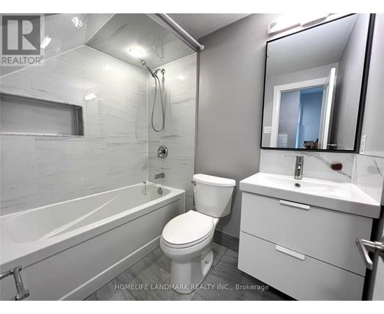 A white bathroom with a toilet, sink, and bathtub.