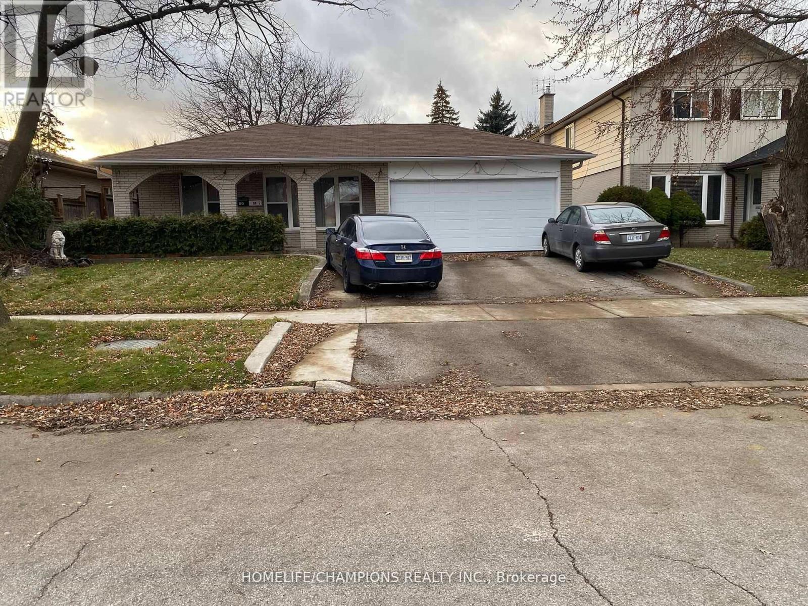 A house with a car parked in front of it.
