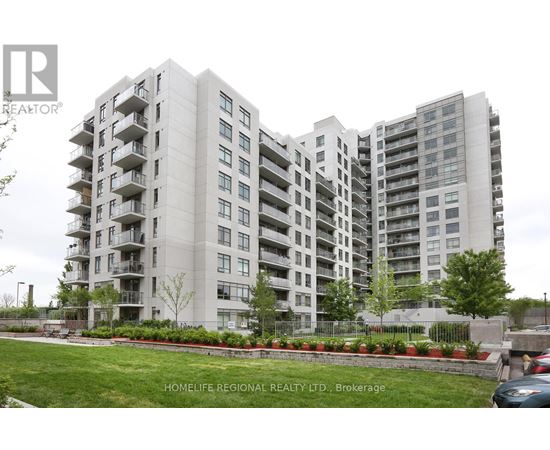 A large apartment building with a green lawn in front.