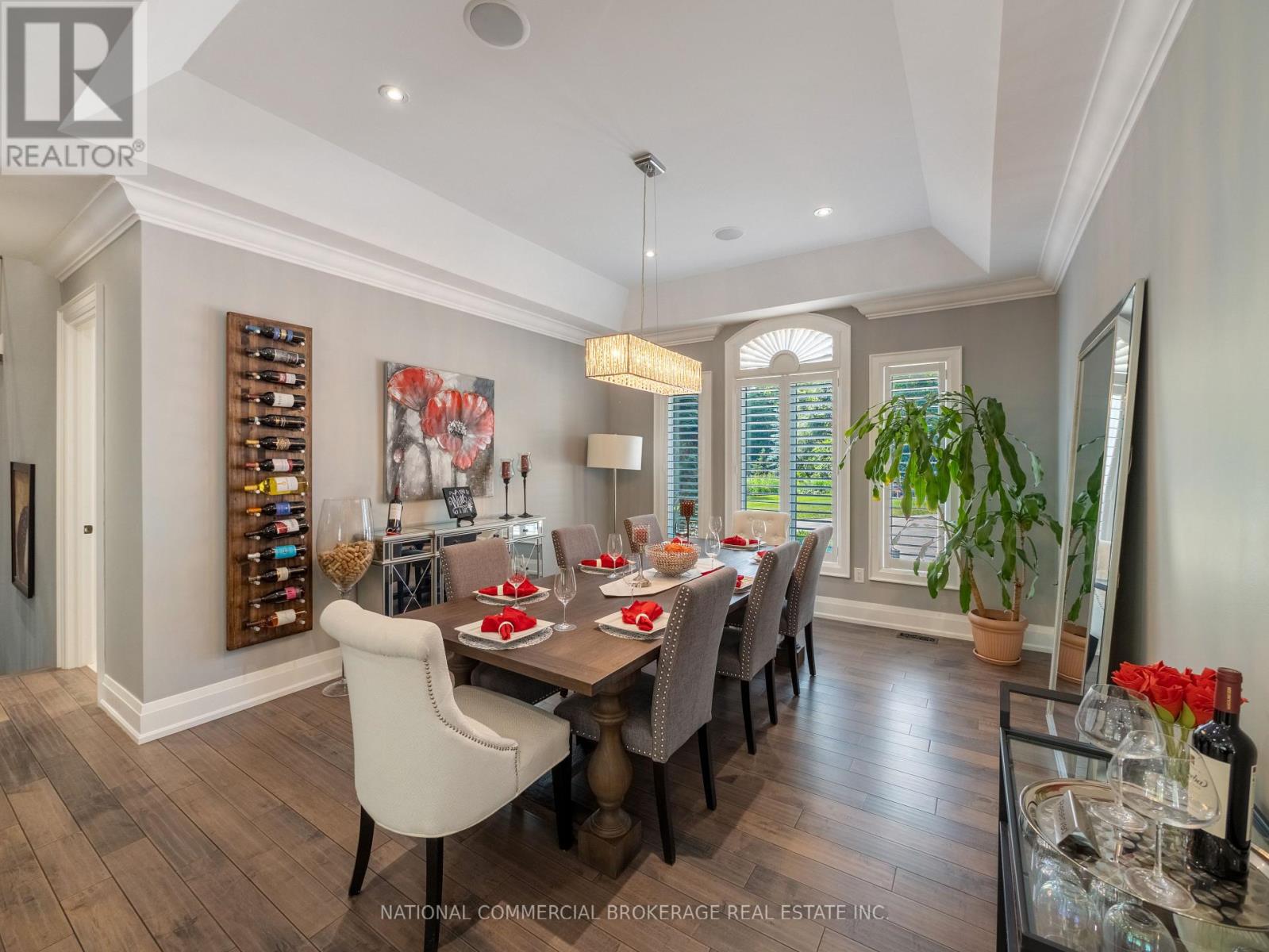 A dining room with a wooden table and chairs.
