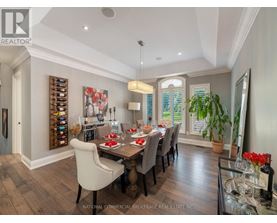 A dining room with a wooden table and chairs.