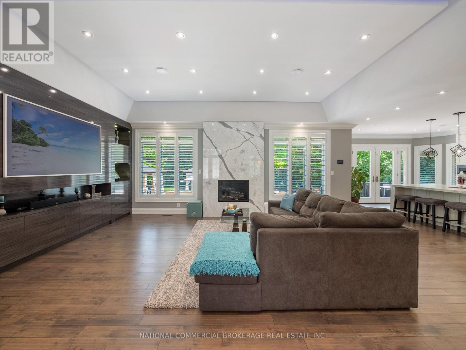 A living room with a brown couch and a television.