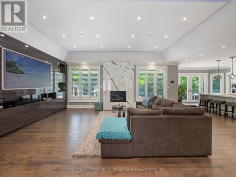 A living room with a brown couch and a television.