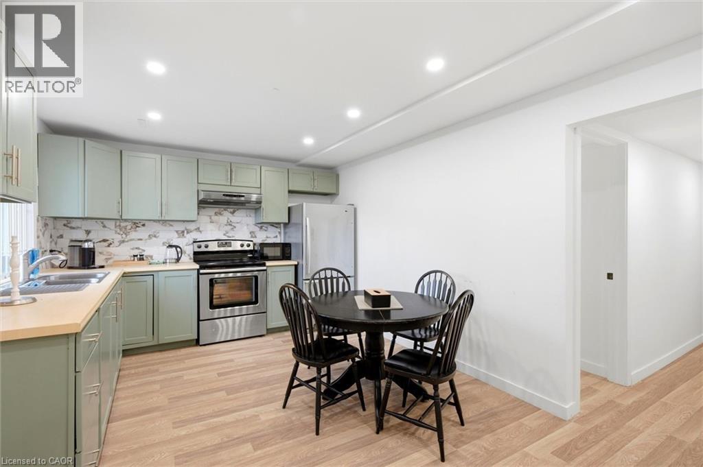 A kitchen with a table and chairs in the middle of the room.