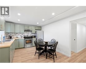 A kitchen with a table and chairs in the middle of the room.