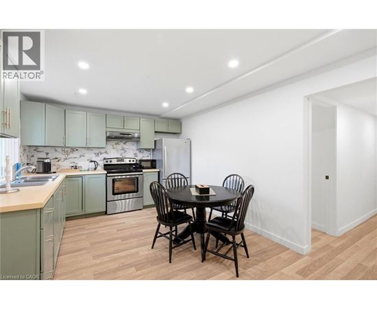 A kitchen with a table and chairs in the middle of the room.
