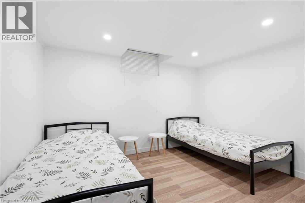 A bedroom with two beds and a small table.