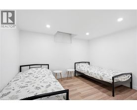 A bedroom with two beds and a small table.