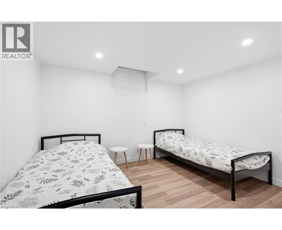 A bedroom with two beds and a small table.