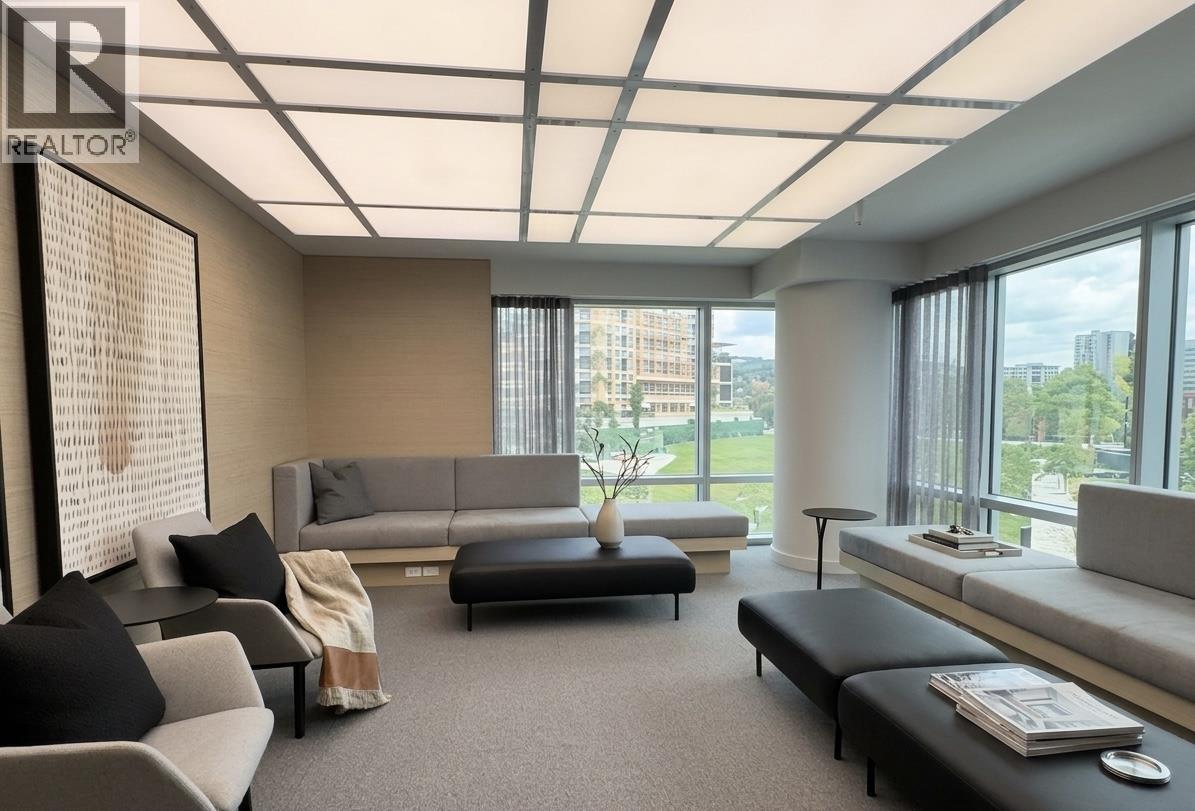A living room with a grey sofa and a black coffee table.