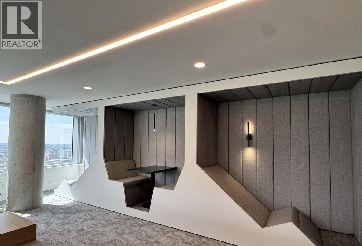 A modern office space with a reception desk and a view of the city.