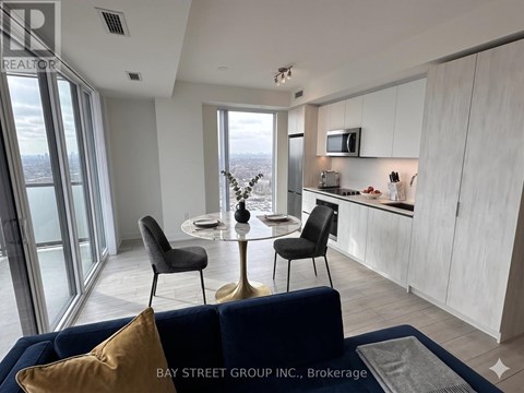 A modern kitchen with a dining table and chairs.