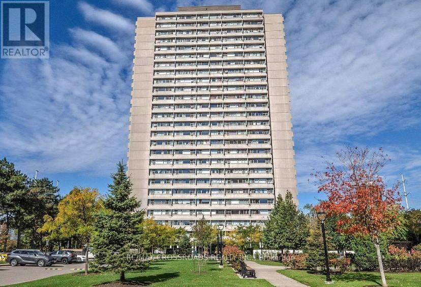 A tall building with a lawn in front of it.