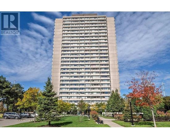 A tall building with a lawn in front of it.
