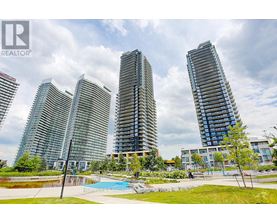 A group of modern high-rise buildings with a swimming pool in the foreground.