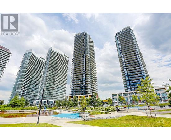 A group of modern high-rise buildings with a swimming pool in the foreground.