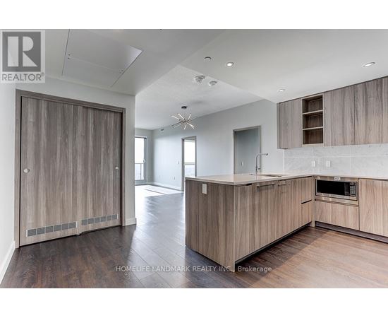 A modern kitchen with wooden cabinets and a large island.
