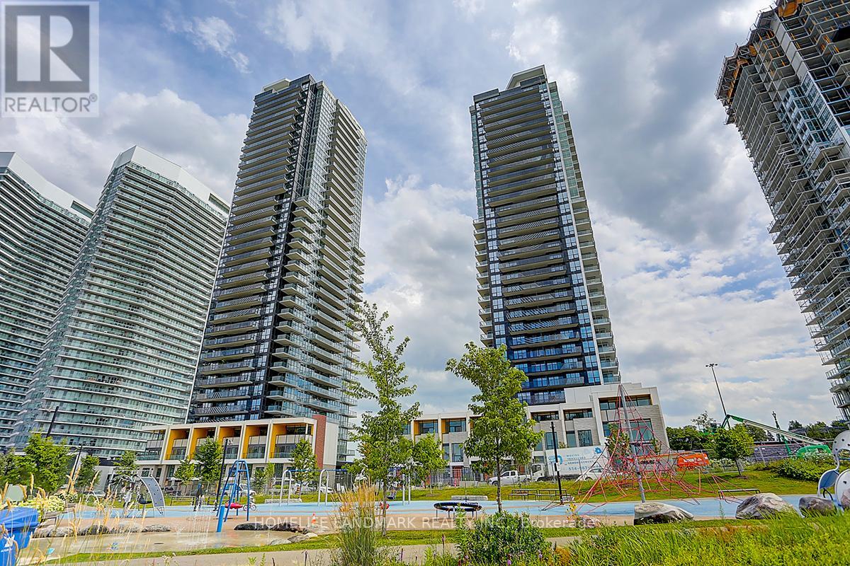 A view of a city with tall buildings and a playground in the foreground.