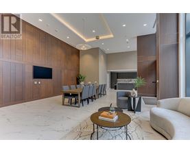 A modern living room with a wooden accent wall and a large flat-screen TV.