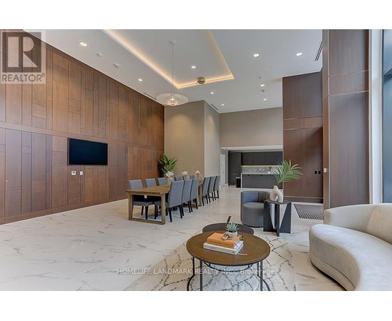 A modern living room with a wooden accent wall and a large flat-screen TV.