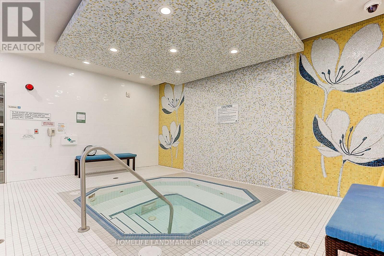A small indoor pool with a metal railing.