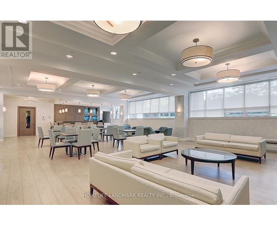 A spacious living room with a dining table and chairs.