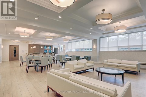 A spacious living room with a dining table and chairs.