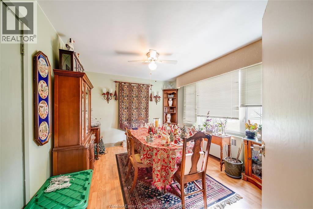 A dining room with a table set for a meal.