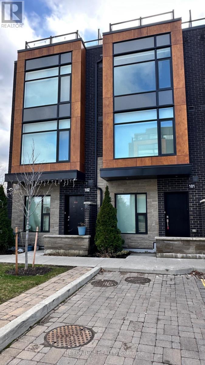 A modern two-story building with a black front door and windows.