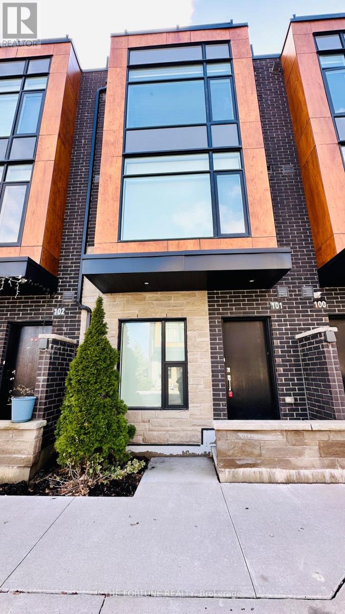 A modern house with a black door and a glass window.