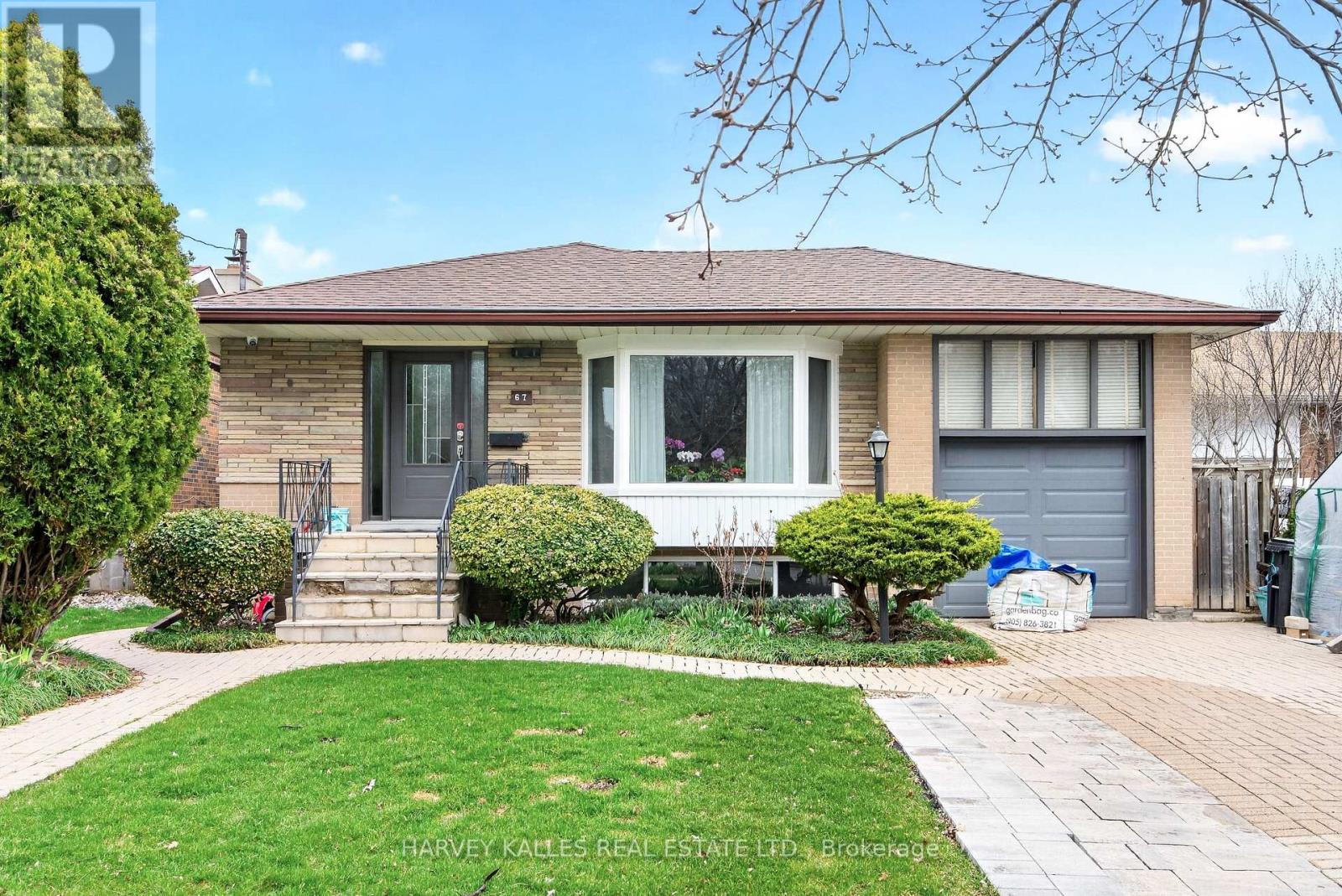 A house with a front yard and a driveway.