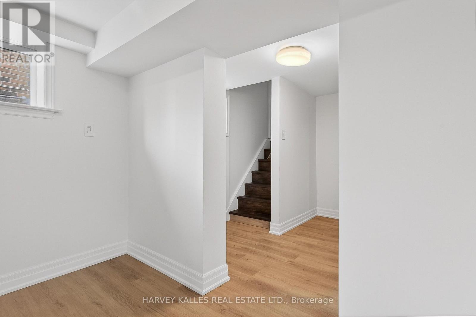 A room with a staircase leading to another room.