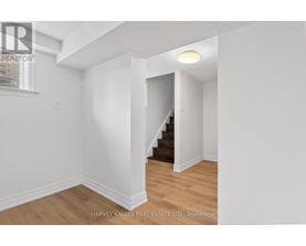 A room with a staircase leading to another room.