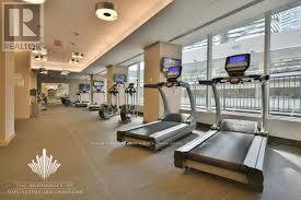 A gym with treadmills and elliptical machines.