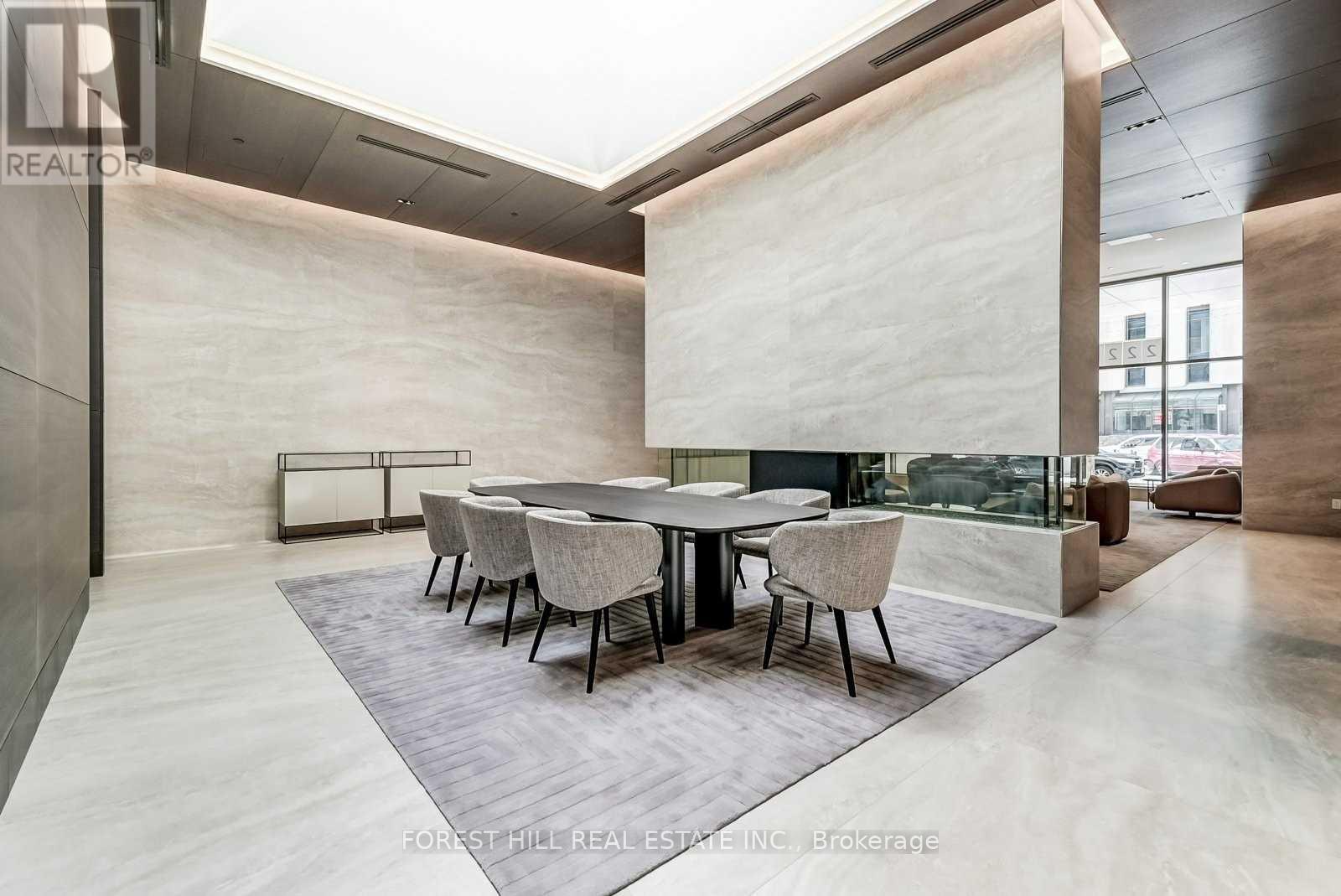 A modern dining room with a glass table and chairs.