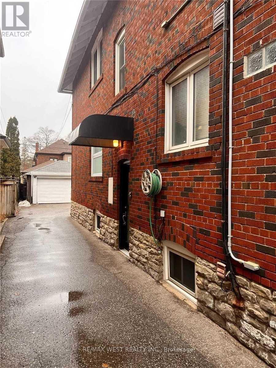 A red brick building with a black awning and a white garage door.
