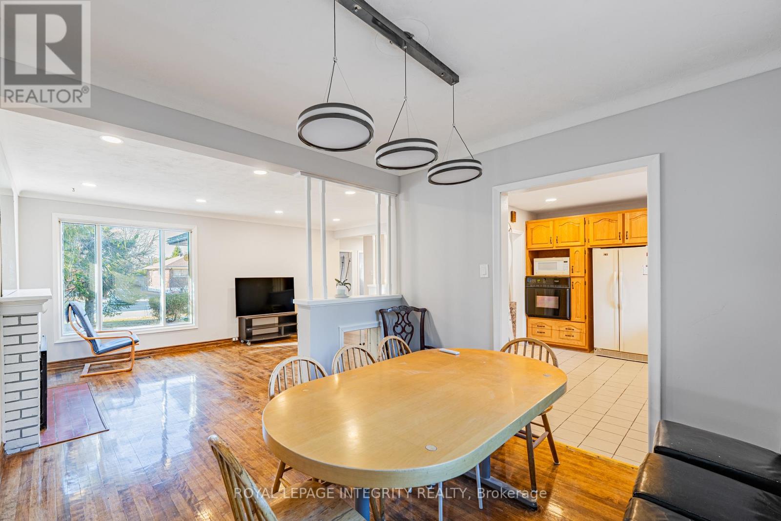 A modern living room with a wooden table and chairs.