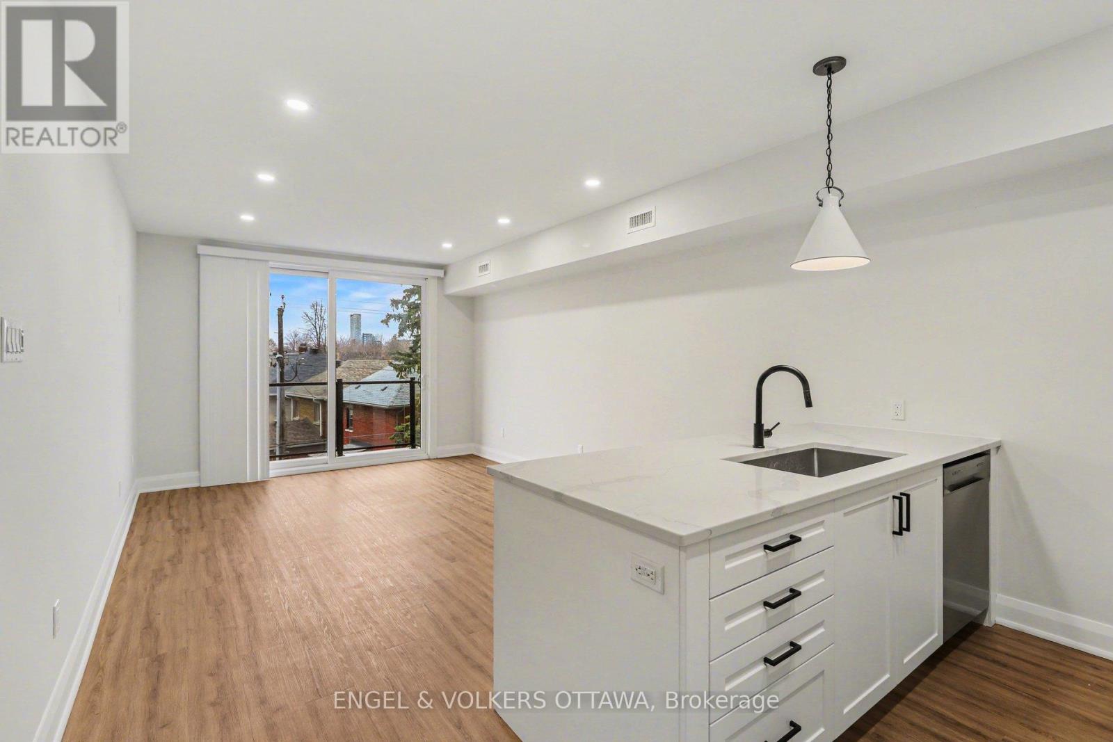 A kitchen with white cabinets and a sink is shown in the image.