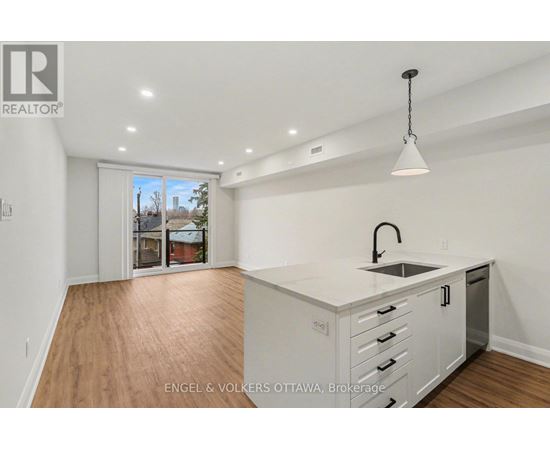 A kitchen with white cabinets and a sink is shown in the image.