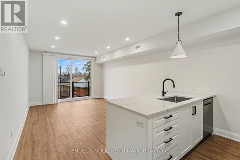 A kitchen with white cabinets and a sink is shown in the image.