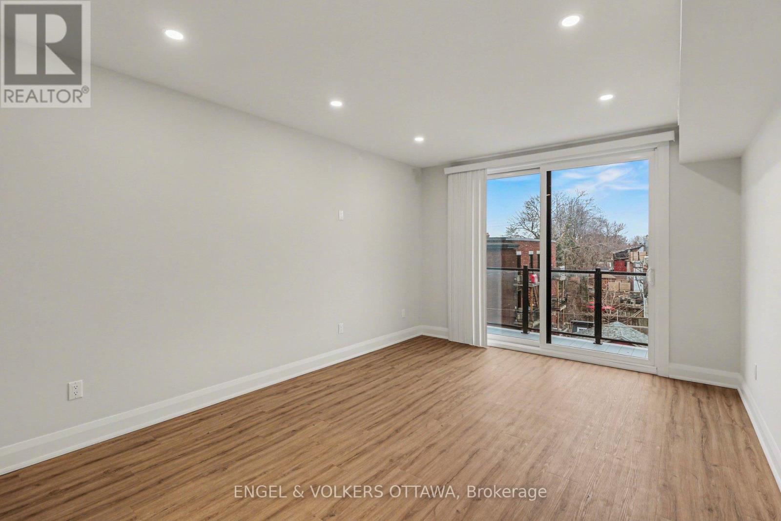 A room with a sliding glass door leading to a balcony.