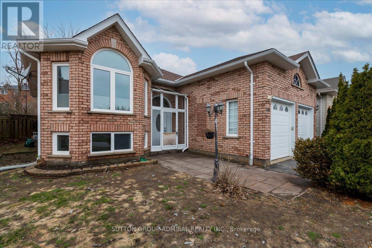 A brick house with a white door and windows is for sale.